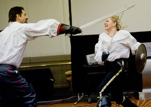 Mike Sakuta (left) and Nicole Harsch demonstrate the proper technique to using swords during one of the numerous seminars at DragonCon in downtown Atlanta on Saturday, August 31, 2013. 