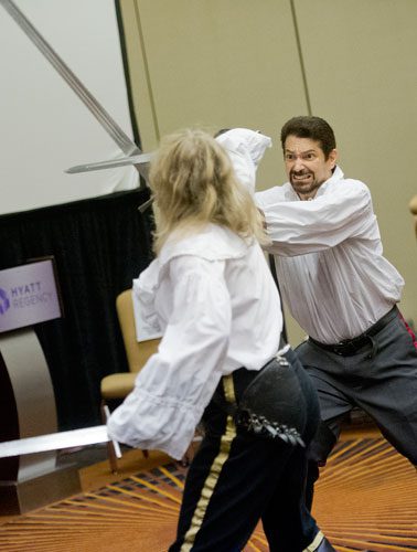 Mike Sakuta (right) and Nicole Harsch demonstrate the proper technique to using swords during one of the numerous seminars at DragonCon in downtown Atlanta on Saturday, August 31, 2013. 