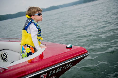 Jayden Cohen stands in the bow of his family's boat as they take a break from cruising on Lake Lanier in Gainesville on Sunday, September 1, 2013.