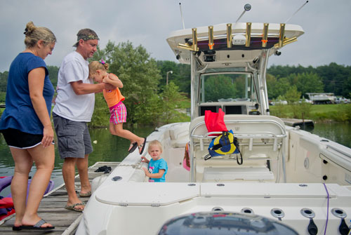 Karen Armstrong (left) and her husband Todd load their daughters Ansley and Megyn onto their boat at Gainesville Marina on the shore of Lake Lanier on Sunday, September 1, 2013. 