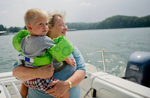 Matthew Armstrong (left) is held by his grandmother Cindy Custard as they ride on a boat across Lake Lanier in Gainesville on Sunday, September 1, 2013. 