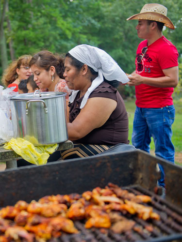 Teresa Herrera (center), Dennis De La Cruz and Yuseli Ramirez eat during a family picnic at Van Pugh Park on the shore of Lake Lanier in Flowery Branch on Sunday, September 1, 2013.