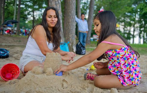 Jemy Urena (right) makes a sand castle with Petra Gaellos at Van Pugh Park in Flowery Branch on Sunday, September 1, 2013. 