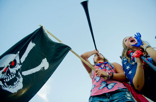 Alpharetta fans Lauren Reed (left) and Lexi Ruppel cheer from the stands before their game against Lovejoy on Friday, September 13, 2013. 