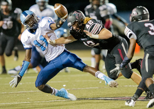 Lovejoy's Preston Wiliams (11) keeps a wild pass from being intercepted by Alpharetta's Bryce Grauss (42) on Friday, September 13, 2013. 
