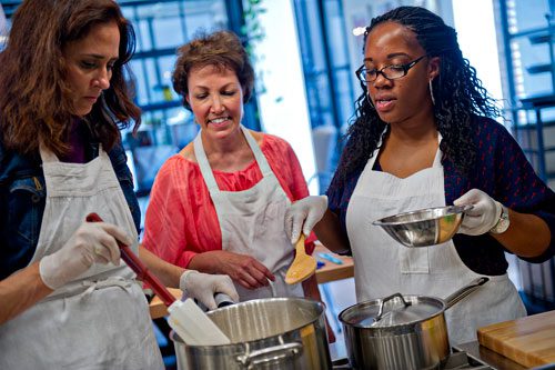 Kristin Stockton (left) Martha McMillin and Morgan Dooley prepare to can pear preserves during a canning class at The Preserving Place in Atlanta on Saturday, September 14, 2013. 