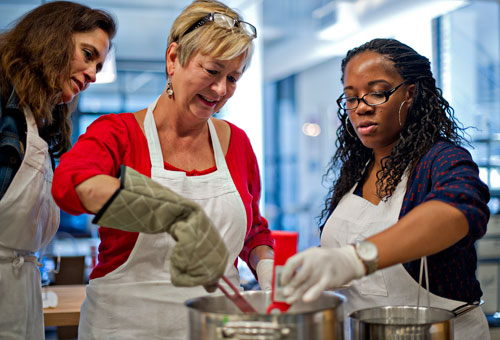 Kristin Stockton (left), Dawn Nelson and Morgan Dooley prepare to can pear preserves during a canning class at The Preserving Place in Atlanta on Saturday, September 14, 2013. 