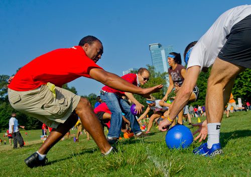 Eric Clark (left) tries to beat Zack Wilcox to the ball at the start of a game of dodgeball during the Boys & Girls Clubs of America's Day for Kids at Piedmont Park in Atlanta on Saturday, September 7, 2013. 