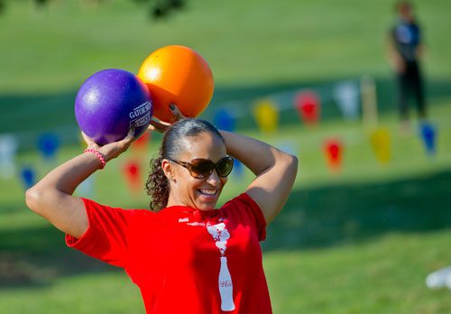 Summer Butler looks for a target as sheholds two balls over her head during a game of dodgeball during the Boys & Girls Clubs of America's Day for Kids at Piedmont Park in Atlanta on Saturday, September 7, 2013.