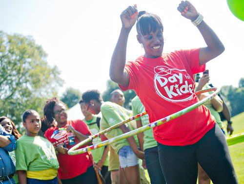 Jackie Joyner-Kersee competes in a hula hoop contest during the Boys & Girls Clubs of America's Day for Kids at Piedmont Park in Atlanta on Saturday, September 7, 2013. 