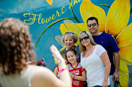 Dustin Bair (right), Brooke Taylor, her daughter Savannah and Kathy Blair have their photo taken by Nicole Augustine before heading into the Yellow Daisy Festival at Stone Mountain Park on Saturday, September 7, 2013. 