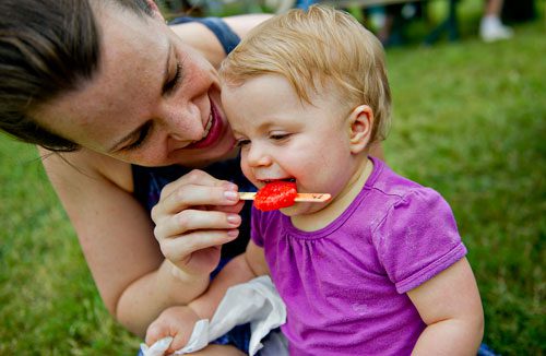 Quinn McVeigh (right) is fed a popsicle by her mother Adrianne during the Yellow Daisy Festival at Stone Mountain Park on Saturday, September 7, 2013. 