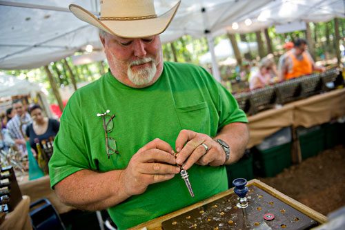 Bud Patterson makes a hand crafted wine stopper during the Yellow Daisy Festival at Stone Mountain Park on Saturday, September 7, 2013. 