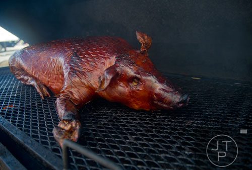 A 120 pound whole hog sits in a smoker during the Atlanta Bar-B-Q Festival at Atlantic Station in Midtown on Saturday, September 14, 2013.
