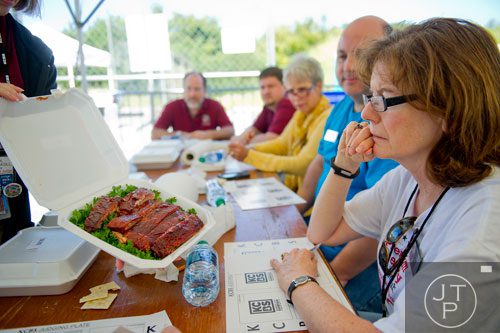 Wanda Gorges, one of the numerous judges at this year's competition, takes a look at a plate of spare ribs during the Atlanta Bar-B-Q Festival at Atlantic Station in Midtown on Saturday, September 14, 2013. 