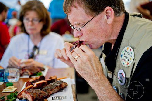 Bob Williams, one of the numerous judges at this year's competition, takes a bite of spare ribs during the Atlanta Bar-B-Q Festival at Atlantic Station in Midtown on Saturday, September 14, 2013.