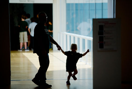Dave Howard (left) holds his daughter Stormy Rose's hand as they walk through the High Museum of Art in the Midtown neighborhood of Atlanta on Thursday, August 29, 2013. 