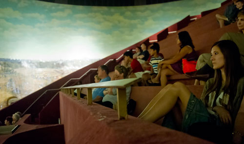 Jenna Gomes (right) looks at the different scenes from the Battle of Atlanta at the Cyclorama in the Grant Park neighborhood of Atlanta on Thursday, August 29, 2013. 