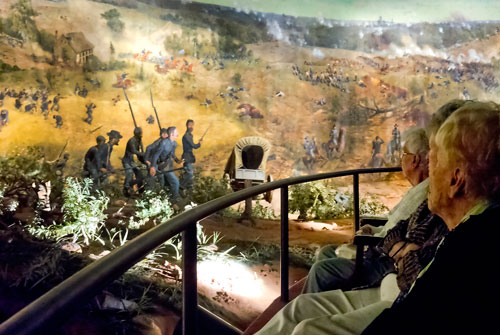 Frieda Pereira (left), Janice Manassa and Flo Auerbach look at the different scenes from the Battle of Atlanta at the Cyclorama in the Grant Park neighborhood of Atlanta on Thursday, August 29, 2013. 