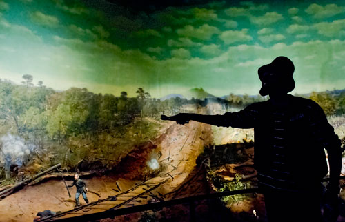 Derrick Williams (right) uses a flashlight to point out different features of the Cyclorama in the Grant Park neighborhood of Atlanta on Thursday, August 29, 2013. 