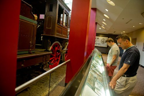 Todd Curry (right) and his son Abe look at the Texas locomotive inside the museum portion of the Cyclorama in the Grant Park neighborhood of Atlanta on Thursday, August 29, 2013. 