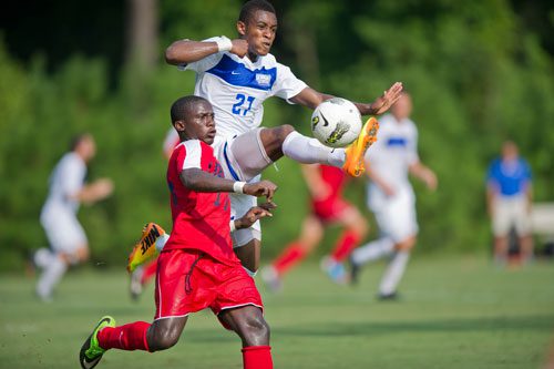 Georgia State's Andy Anglade (27) kicks the ball away from Liberty's Blessing Tahuona during their game on Friday, August 30, 2013.
