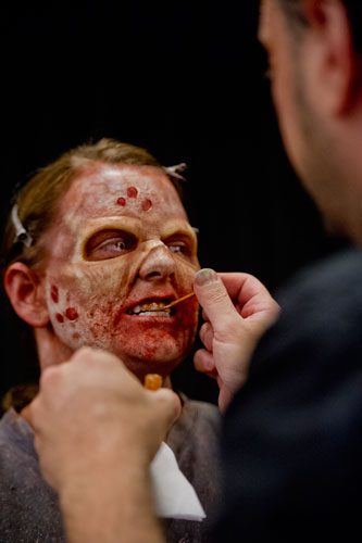 Emily Allen has some special effects applied to her teeth by R.J. Haddy, one of the contestants on the SyFy Channel's FaceOff reality television show, during DragonCon in downtown Atlanta on Saturday, August 31, 2013.
