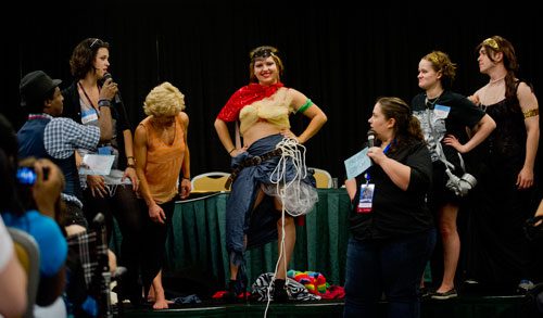 Savannah Hoover (center) stands on stage in her newly designed costume during Project Cosplay, one of the numerous seminars at DragonCon in downtown Atlanta on Saturday, August 31, 2013.