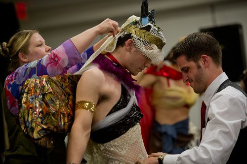 Cindy Henderson (left) and Joshua Hamburg (right) put the final touches on Drew Mergenthaler's newly designed costume during Project Cosplay, one of the numerous seminars at DragonCon in downtown Atlanta on Saturday, August 31, 2013.
