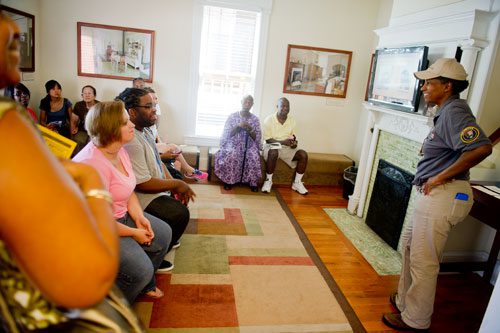 Elaine Edwards talks with visitors before beginning a tour of the birth home of Dr. King at the Martin Luther King Jr. National Historic Site in the Old Fourth Ward neighborhood of Atlanta on Wednesday, September 4, 2013.