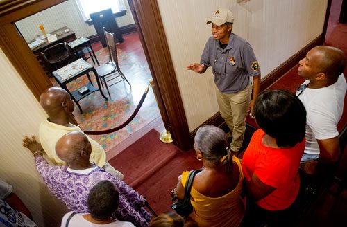 Elaine Edwards (top right) gives Bruce Walton, Bev Walker, Enid Sewell, Agnes Wallace and James and Ben Ayeni a tour as they walk through the birth home of Dr. King at the Martin Luther King Jr. National Historic Site in the Old Fourth Ward neighborhood of Atlanta on Wednesday, September 4, 2013. 