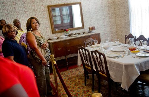 Gere Perry (left), Ben Ayeni and Jill Bartee walk through the birth home of Dr. King at the Martin Luther King Jr. National Historic Site in the Old Fourth Ward neighborhood of Atlanta on Wednesday, September 4, 2013. 