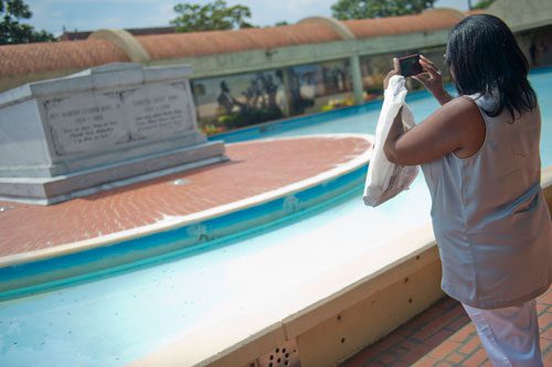 Val Thompson takes a photograph of Dr. and Mrs. Martin Luther King Jr.'s tombs at the Martin Luther King Jr. National Historic Site in the Old Fourth Ward neighborhood of Atlanta on Wednesday, September 4, 2013.