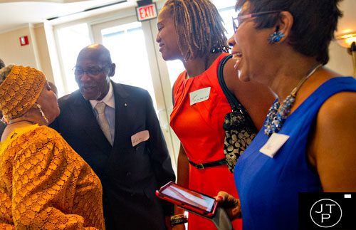Willie H. Fowler (center), his daughter Tamara and wife Carol (right) socialize with Elisabeth Omilami during the first annual Fowler Family Celebration of Love at Villa Christina in Atlanta on Sunday, September 15, 2013. 