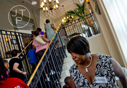 Ottive Breedlove (bottom) climbs the stairs as she and others head to the banquet room at Villa Christina in Atlanta during the first annual Fowler Family Celebration of Love on Sunday, September 15, 2013. 