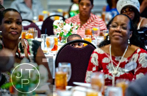 Demarcus Miller (center) peers through the back of his chair during the first annual Fowler Family Celebration of Love at Villa Christina in Atlanta on Sunday, September 15, 2013. 
