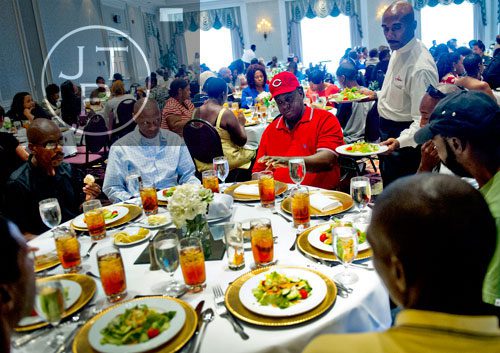 Marvin Perkins Jr. (left), A.W. Franklin and Albert Williams are served salads by Thomas Prince Jr. during the first annual Fowler Family Celebration of Love at Villa Christina in Atlanta on Sunday, September 15, 2013. 