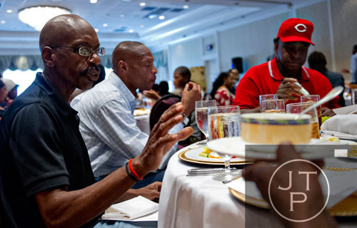 Marvin Perkins Jr. (left) is passed salad dressing as he eats lunch with A.W. Franklin and Albert Williams during the first annual Fowler Family Celebration of Love at Villa Christina in Atlanta on Sunday, September 15, 2013. 