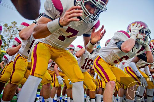 Lassiter's Will Anderson (7) and Parker Styles break down with their team before their game against Walton on Friday, October 4, 2013.