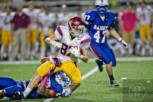 Lassiter's Pearson Vanhorn (87) is tackled by Walton's DJ Smith on Friday, October 4, 2013. 