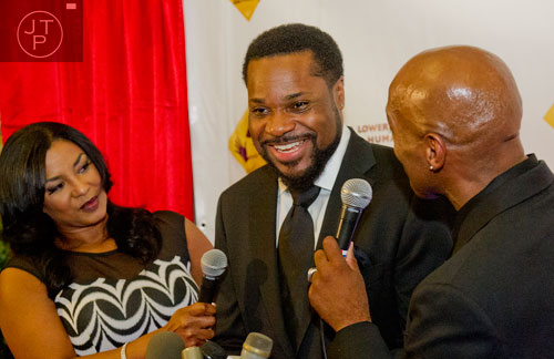 Malcolm Jamal Warner (center) is interviewed by Shaunya Chavis (left) and Stepp Stewart as he makes his way down the red carpet for the Rev. Dr. Joseph E. Lowery 92nd Birthday Celebration at Morehouse College in Atlanta on Sunday, October 6, 2013. 
