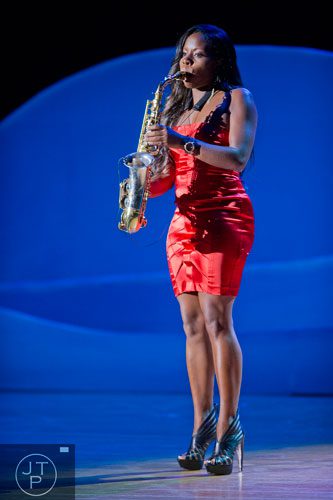 Tia Fuller plays her saxophone as she performs on stage during I've Known Rivers: A Legendary Life, a tribute to Joseph E. Lowery's 92nd birthday celebration at Morehouse College in Atlanta on Sunday, October 6, 2013. 