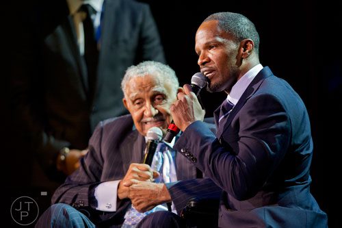 Jamie Foxx (right) kneels next to Rev. Dr. Joseph E. Lowery  during I've Known Rivers: A Legendary Life, a tribute to Lowery's 92nd birthday at Morehouse College in Atlanta on Sunday, October 6, 2013. 