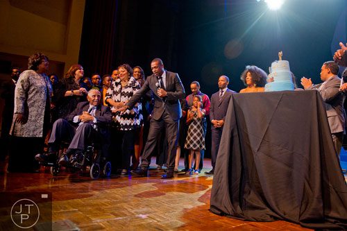 Rev. Dr. Joseph E. Lowery (left seated)  is surrounded by friends and family as his birthday cake is wheeled out on stage  during I've Known Rivers: A Legendary Life, a tribute to Lowery's 92nd birthday at Morehouse College in Atlanta on Sunday, October 6, 2013.