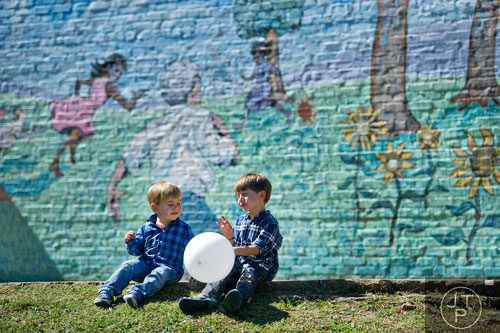 Zephyr Fasman (left) sits with his brother Leo in Harmony Park in Decatur during the Oakhurst Arts & Music Festival on Saturday, October 12, 2013. 