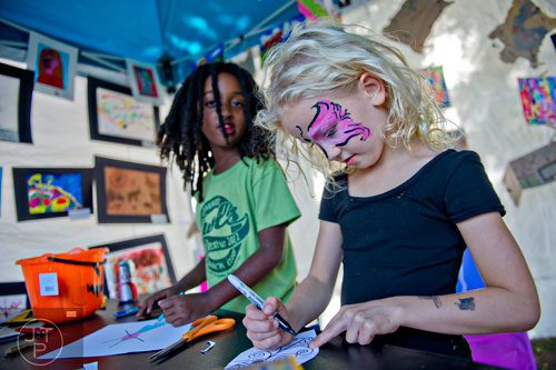 Emily Dunbar (right) and Sofia Kirkcaldy draw pictures during the Oakhurst Arts & Music Festival at Harmony Park in Decatur on Saturday, October 12, 2013. 