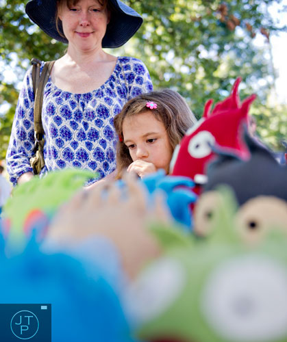 Katherine Caldwell (left) and her daughter Kali look at hand crafted plush toys during the Oakhurst Arts & Music Festival at Harmony Park in Decatur on Saturday, October 12, 2013.
