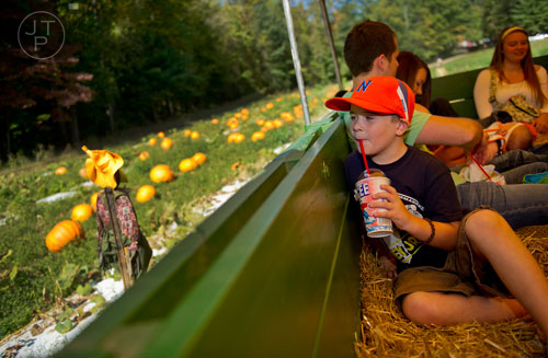 Landon Souther rides a tractor pulled hayride as he makes his way around Burt's Pumpkin Farm in Dawsonville on Sunday, October 13, 2013. 