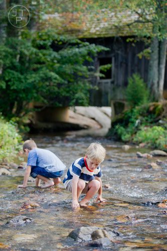 Parker Skelton (right) and his brother Ansley skip rocks in the creek  at Burt's Pumpkin Farm in Dawsonville on Sunday, October 13, 2013. 