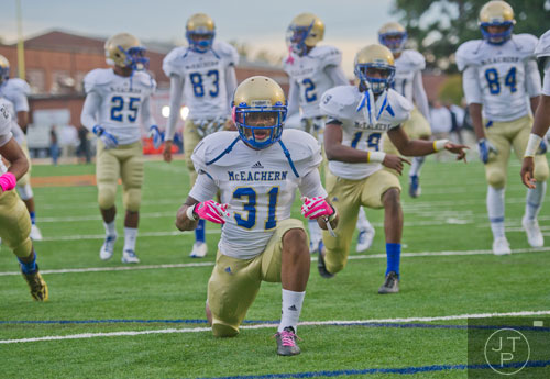 McEachern's Rahmoi Parsons (31) warms up with his team before their game against North Cobb on Friday, October 18, 2013.
